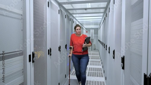 WS Woman with crutch working in data center / Amsterdam, Noord-Holland, Netherlands