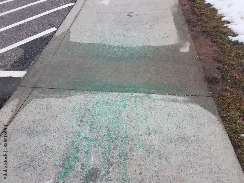 green ice melt pellets on sidewalk or cement