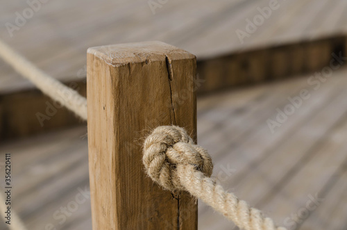 Wooden post. Sea rope. Knot. © Ярослав Марценюк