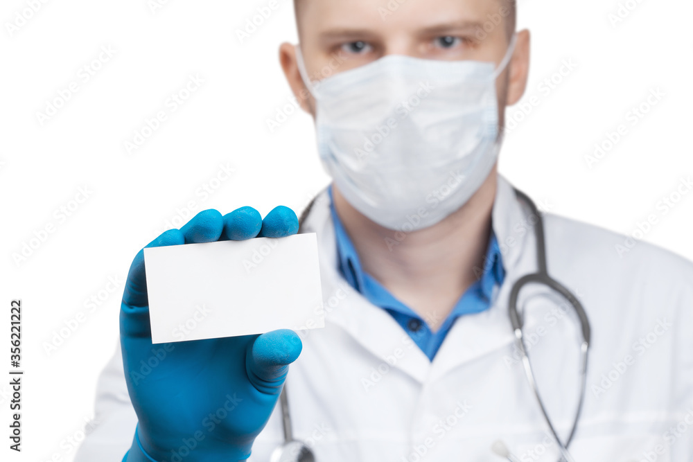Doctor in a mask holging a empty business card Doctor in a mask holging a empty business card