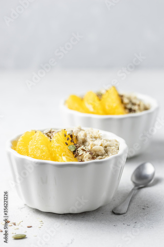 Oats with orange and seeds. Selective focus, copy space.