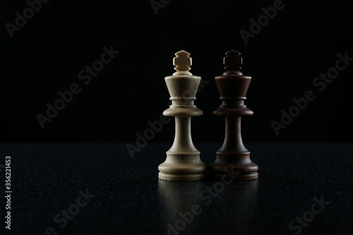 two chess kings on black background