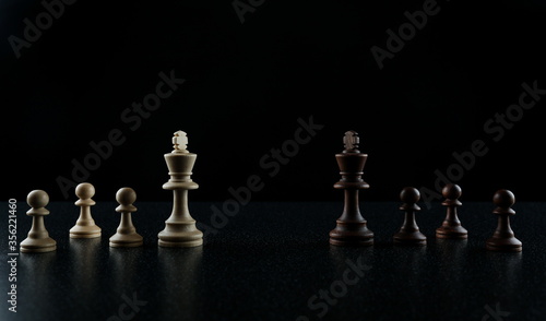 chess kings face to face on black background. concept of a battle