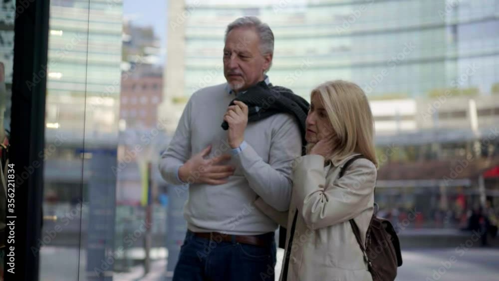 MS Couple window shopping in city / Milan, Italy MS Couple window shopping in city / Milan, Italy