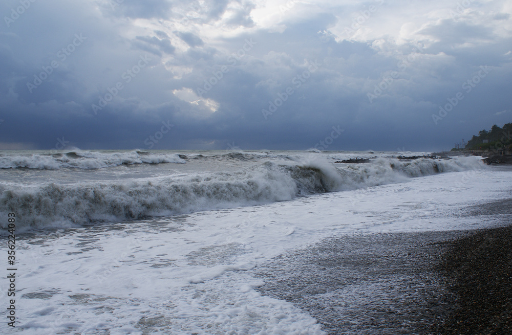 Storm, strong waves, sea coast, pebbles on the beach Storm, strong waves, sea coast, pebbles on the beach
