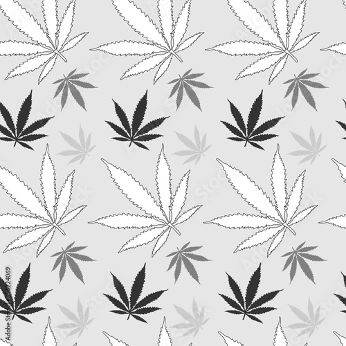 monochrome seamless pattern of cannabis leaves in white light gray and dark gray on a light background