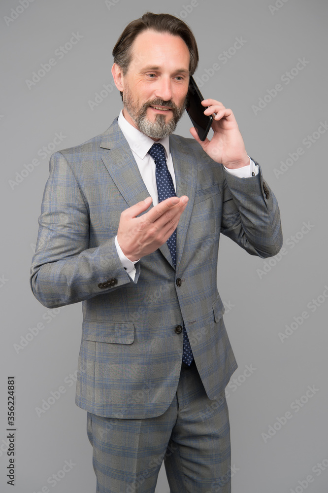 Naklejka premium confident male talk on mobile phone. At work. trying to help someone. ceo in office jacket use smartphone. mature businessman answer email. professional business man in formal suit
