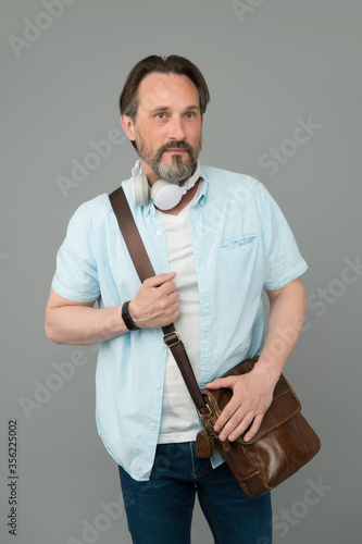 Casual looks gorgeous on him. Bearded man listen to music in casual style. Mature man wear casual clothing grey background. Casual wardrobe. Menswear store. Fashion and style. Everyday clothes