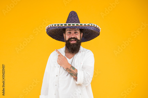 mexican day of the dead. national mexico holiday. mexican hat sombrero and mustache. Enjoying summer. man in festive mood pointing finger. 5th of may. brutal bearded man in mexican sombrero hat photo