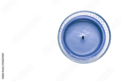 Purple blue fireless candle in glass cup, isolated on white background with copy-space photo