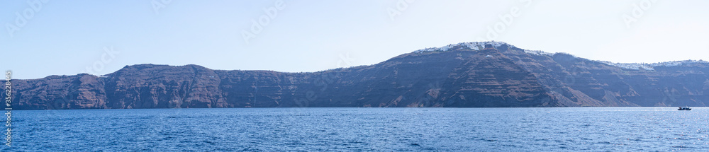 Panoramic view of the coast of the island of Santorini and the village of Imerovigli with the impressive Skaros rock with the Theoskepasti chapel, Santorini Island, Cyclades Archipelago, Greece
