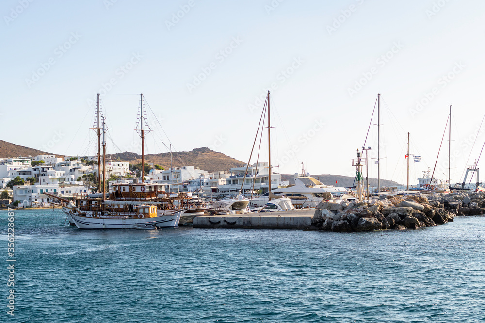 View of the spur and mooring of several sailboats and yachts on one of the islands of the Cyclades archipelago, Greece