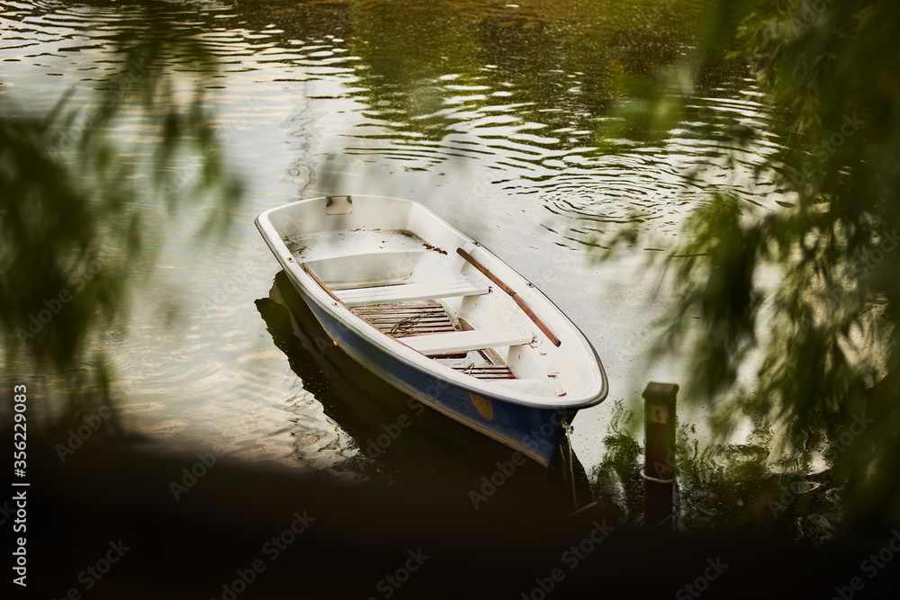 White wooden boat on the lake. White wooden boat with a brown bottom top view. Boat on the lake.