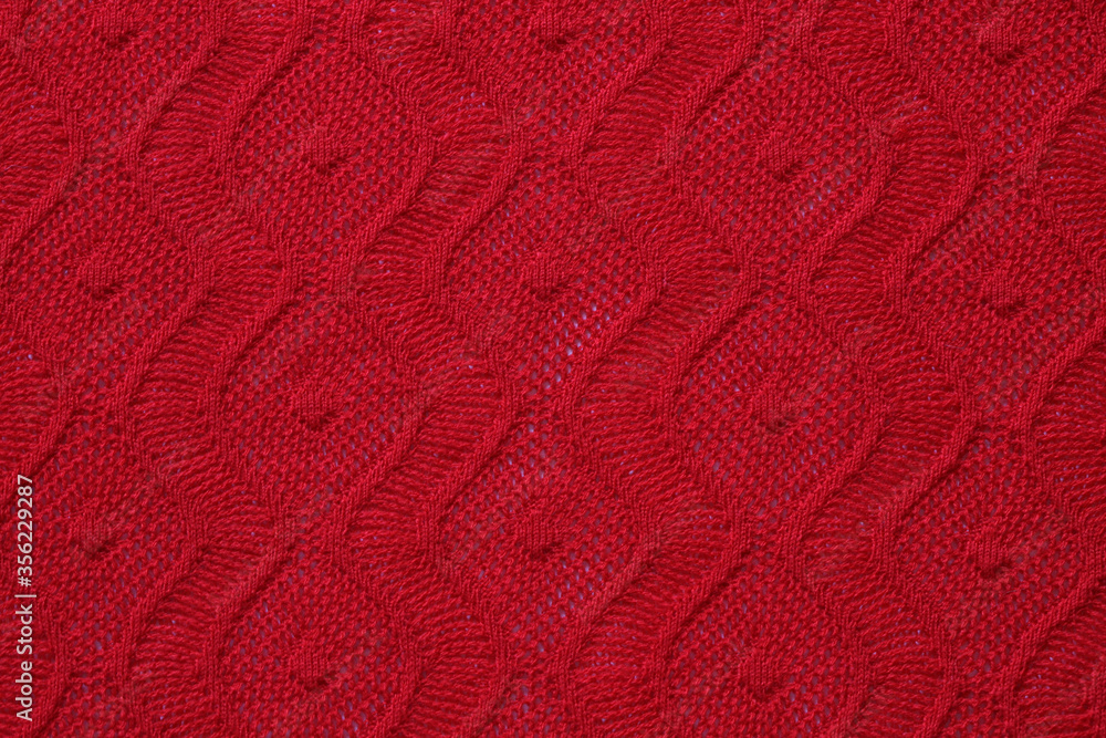 knitted texture of patterns on bright red knitwear,
