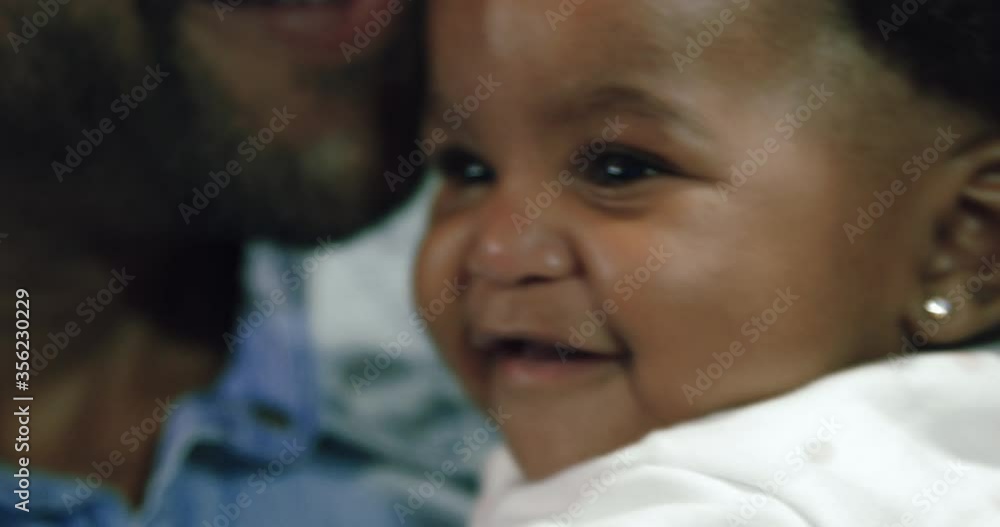 CU SELECTIVE FOCUS Father kissing baby girl (6-11 months) / Claremont, Cape Town, South Africa