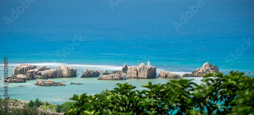Panoramic view of famous granite rocks in blue sea at La Digue, Seychelles. fluffy turquoise sea
