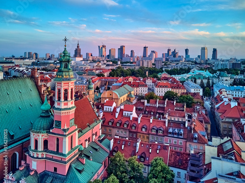 Beautiful panoramic aerial drone view on Warsaw Old town (POL: Stare Miasto) with modern skyscrapers on the horizon, Royal Castle, square and the Column of Sigismund III Vasa at sunset, Poland