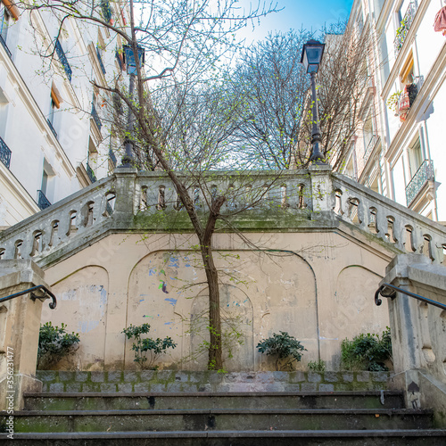 Paris, romantic staircase in Montmartre, typical buildings and floor lamp 