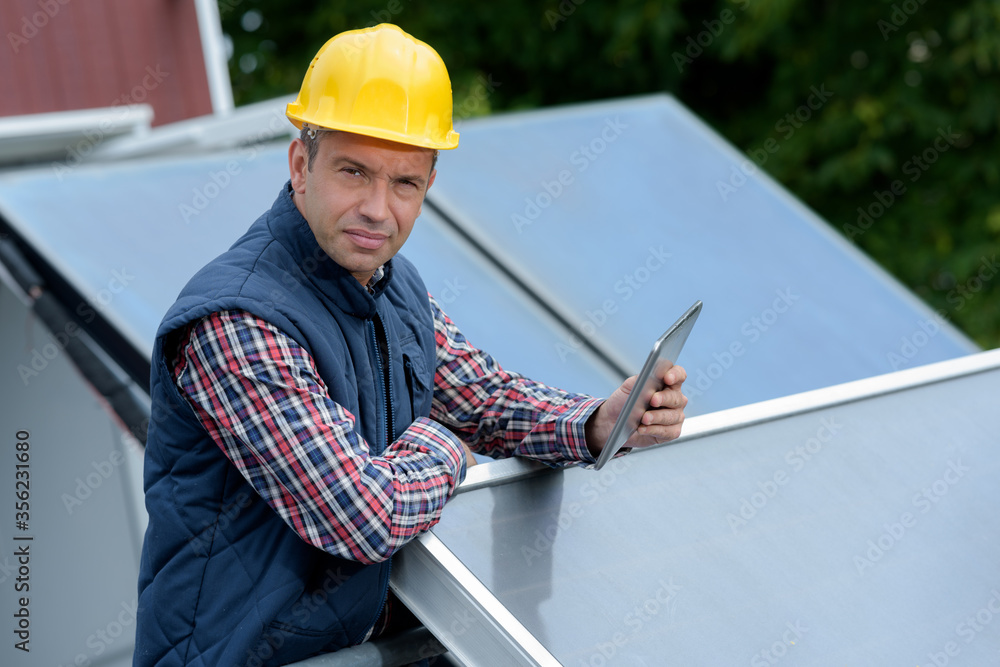 Fototapeta premium a man and the maintenance of solar cells