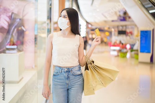 portrait of beautiful woman is wearing face mask in shopping center