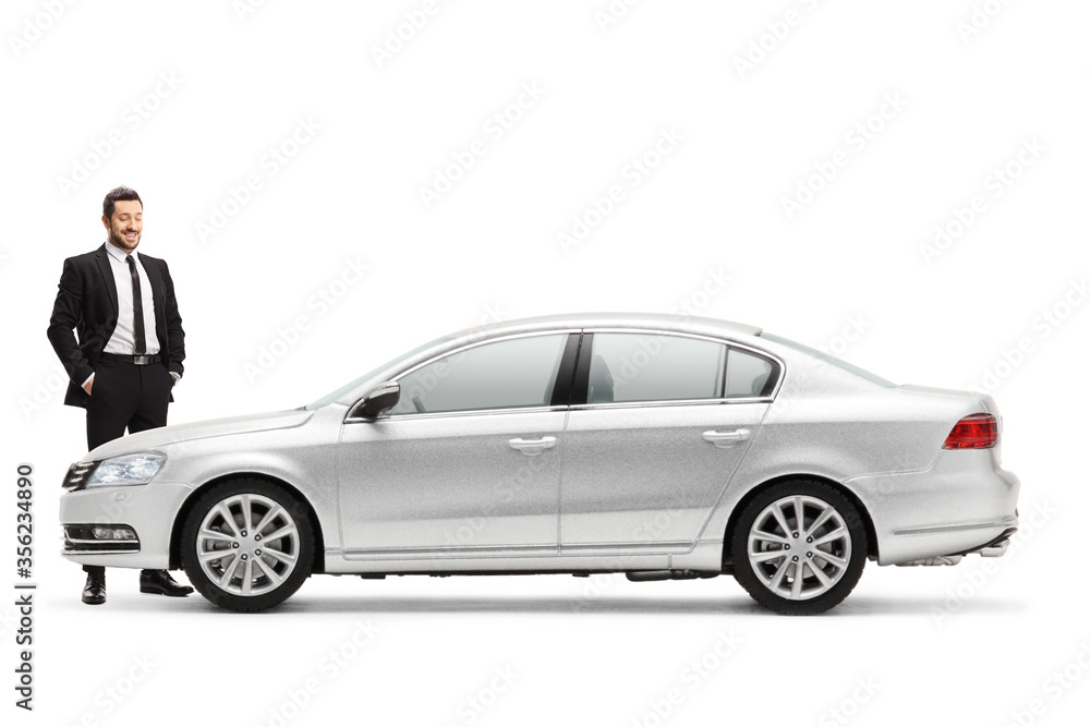 Businessman standing and chacking a new silver car Businessman standing and chacking a new silver car