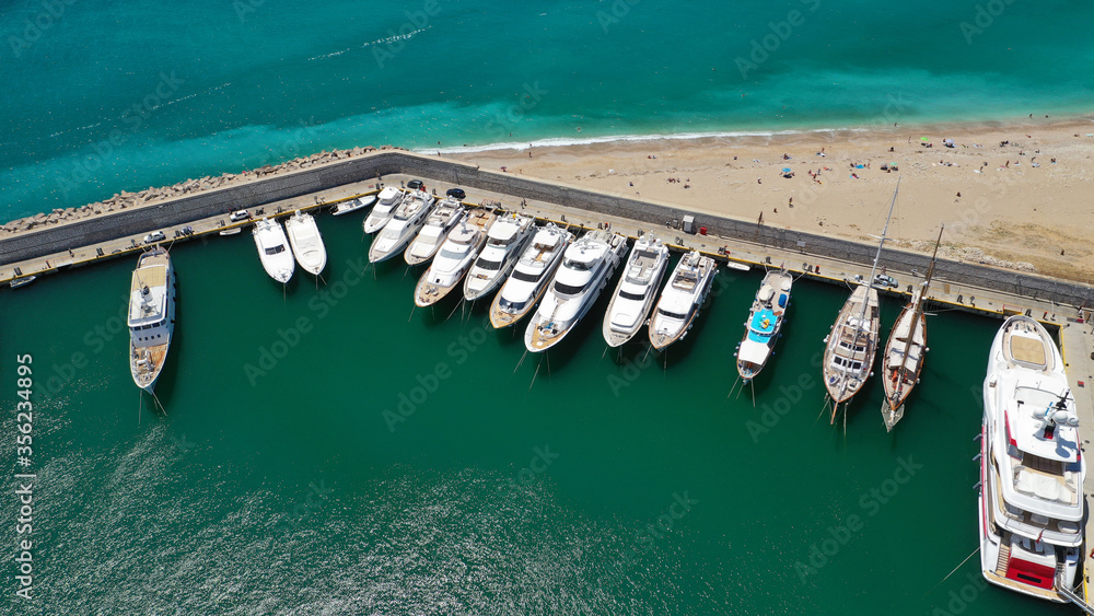 Aerial drone top down photo of luxury yacht anchored in Mediterranean bay marina