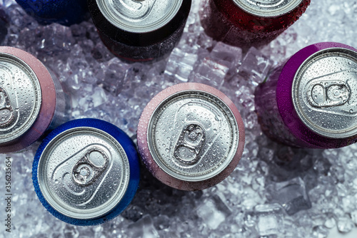 Group of aluminium cans in ice  cold drink.
