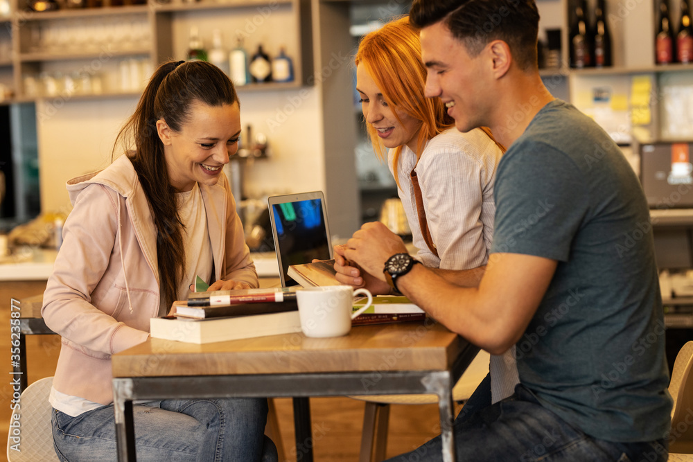 Group of university students hangout at the campus cafe on coffee break. Group of university students hangout at the campus cafe on coffee break.