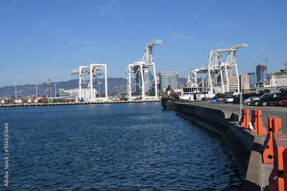 Super Post Panamax cranes at the Port of Oakland. The giant cranes at the apex are roughly the height of a 24 story building and can weigh 1600 to 2000 tons each.