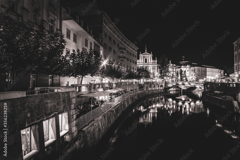 Nightscape of Vienna city with river, restaurants  and tourists around.. Creative background image.22.08.2018