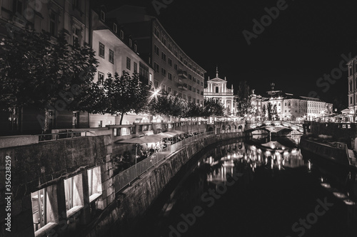 Nightscape of Vienna city with river, restaurants and tourists around.. Creative background image.22.08.2018