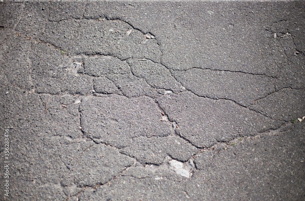 Broken asphalt and cracks on the road surface Broken asphalt and cracks on the road surface