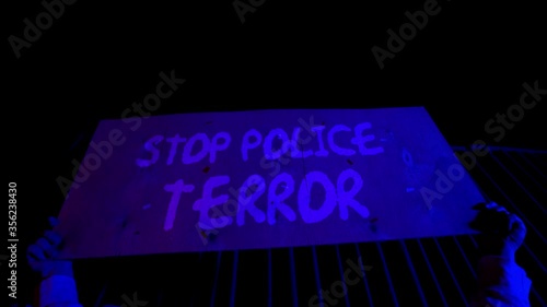 Black Lives Matter. The crowd protests against racial inequality. Riot against police brutality and racism. Red and blue Light police car. Black Rights Protest 