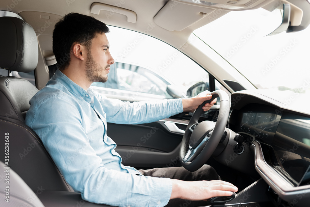 Man driving car. Side view of a man driving an expensive car Man driving car. Side view of a man driving an expensive car