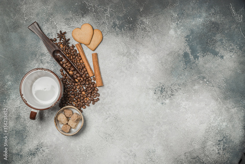 Top view of a Cup of coffee, cappuccino on a table with coffee beans with a wooden spoon