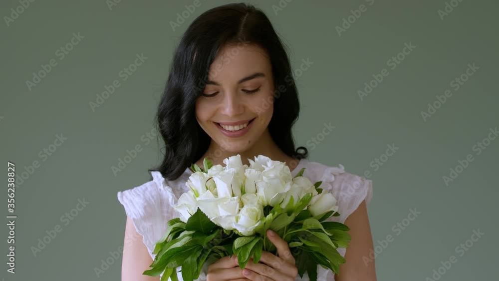 Beautiful young woman with bouquet of white roses on color background Beautiful young woman with bouquet of white roses on color background