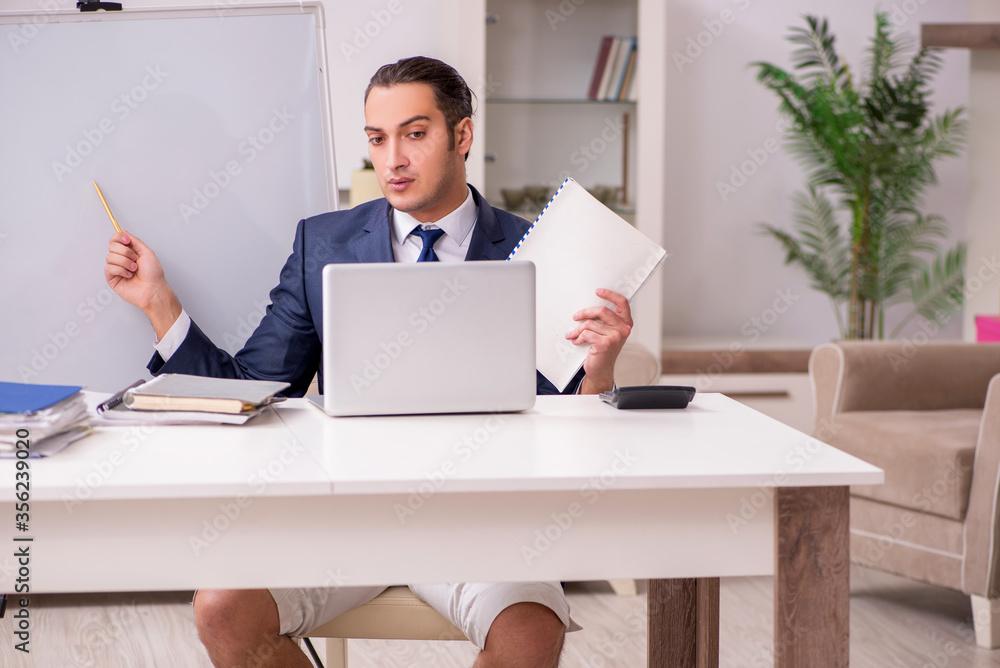 Young male employee working at home during pandemic disease Young male employee working at home during pandemic disease