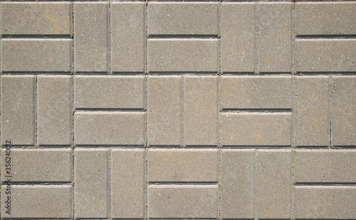 Stone pavement texture. Granite cobblestoned pavement background. Gray brick stone background. Top view
