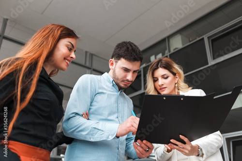 Family couple signs a car purchase agreement