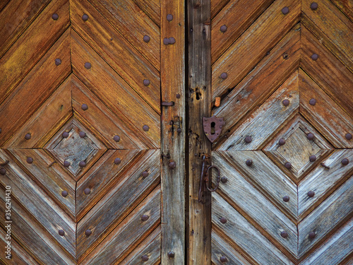 Old wooden door with rustic keyhole