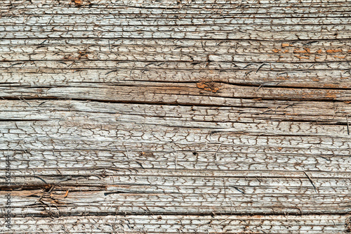 Closeup of texture of an old wooden cracked wall. cracks in natural materials for construction.