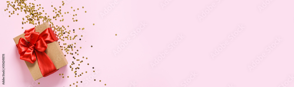Beautiful composition with gifts with red ribbons on a pink background. Box with presents. Top view. Beautiful composition with gifts with red ribbons on a pink background. Box with presents. Top view.