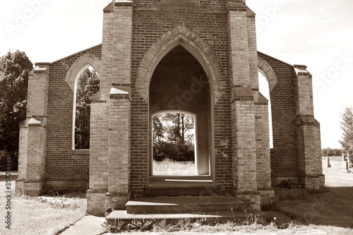 ruins of catholic church built in 1883 and closed 1952 left as tribute to congregation near Chesley Ontario in sepia tones photo