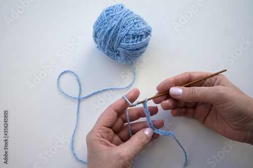 The process of crocheting close-up. Learning to knit. Woman knits.