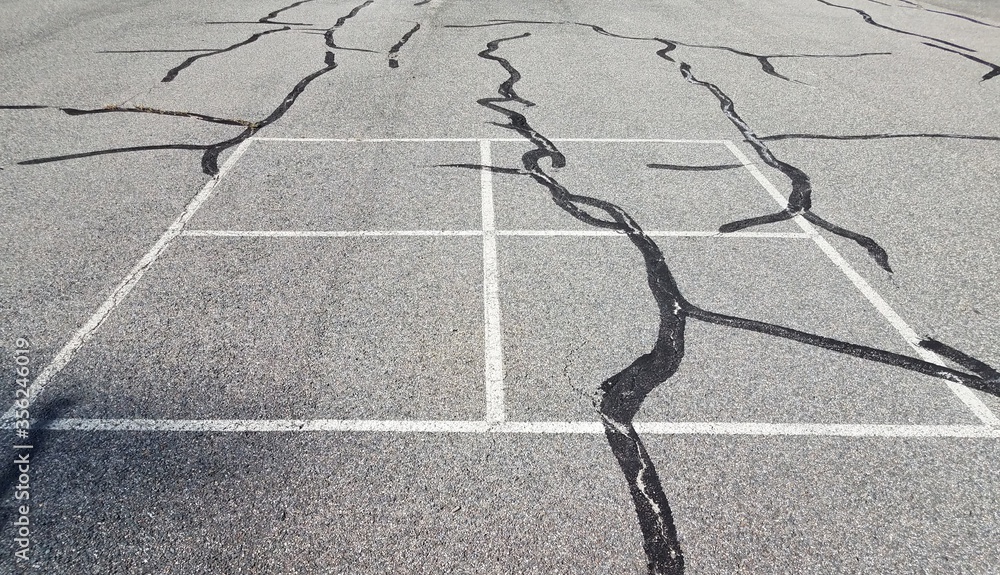 four square lines on black asphalt with cracks Stock Photo Adobe Stock