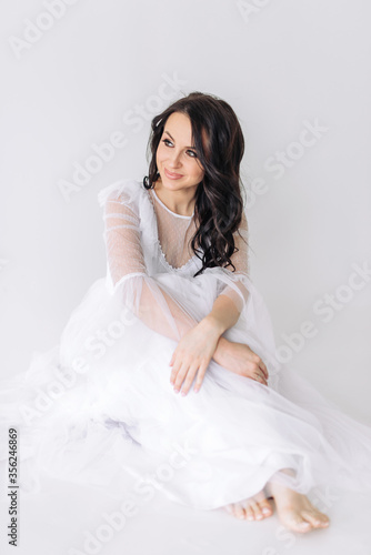 Bride in a beautiful white wedding dress with a lovely smile, beautiful makeup and hairstyle