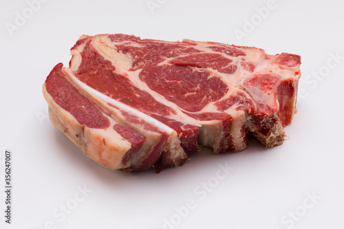 Rib steak without cooking on white background