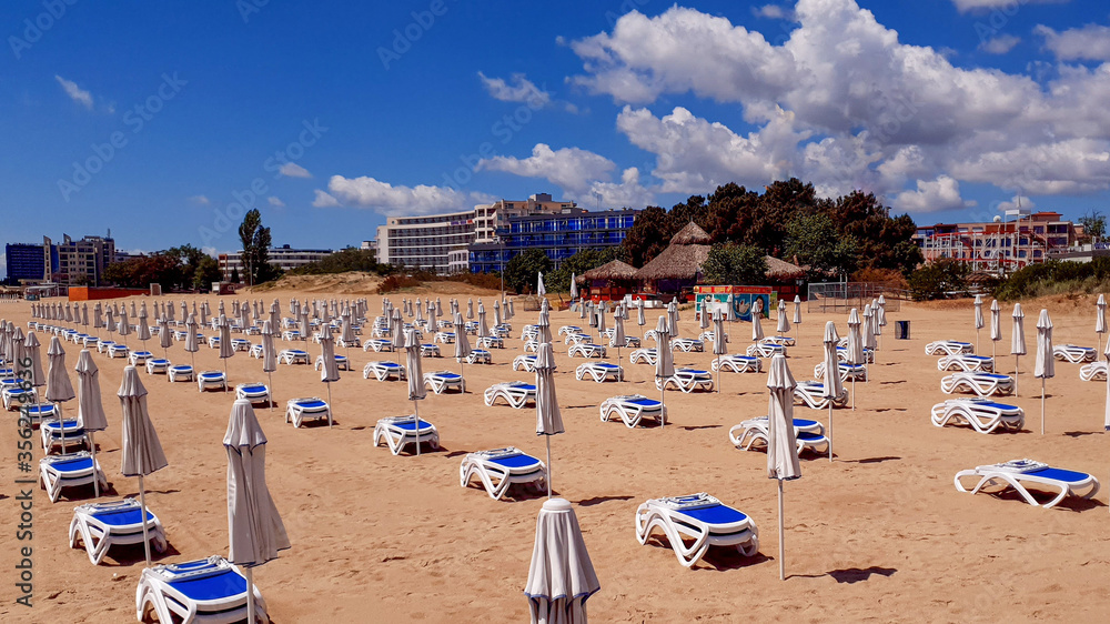 Plenty of free sunbeds on the beach. There are no tourists because of the coronavirus pandemic.