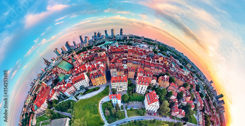 Beautiful panoramic aerial drone view on Warsaw Old town (POL: Stare Miasto) with modern skyscrapers on the horizon, Royal Castle, square and the Column of Sigismund III Vasa at sunset, Poland