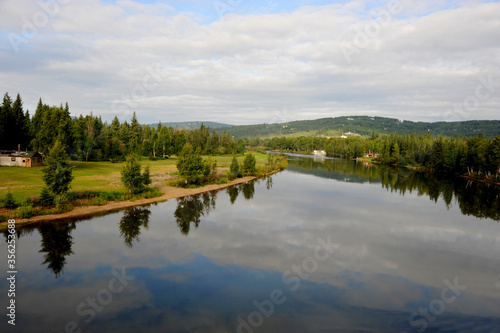 The sky reflected in the calm and tranquil Chena River near Fairbanks, Alaska.